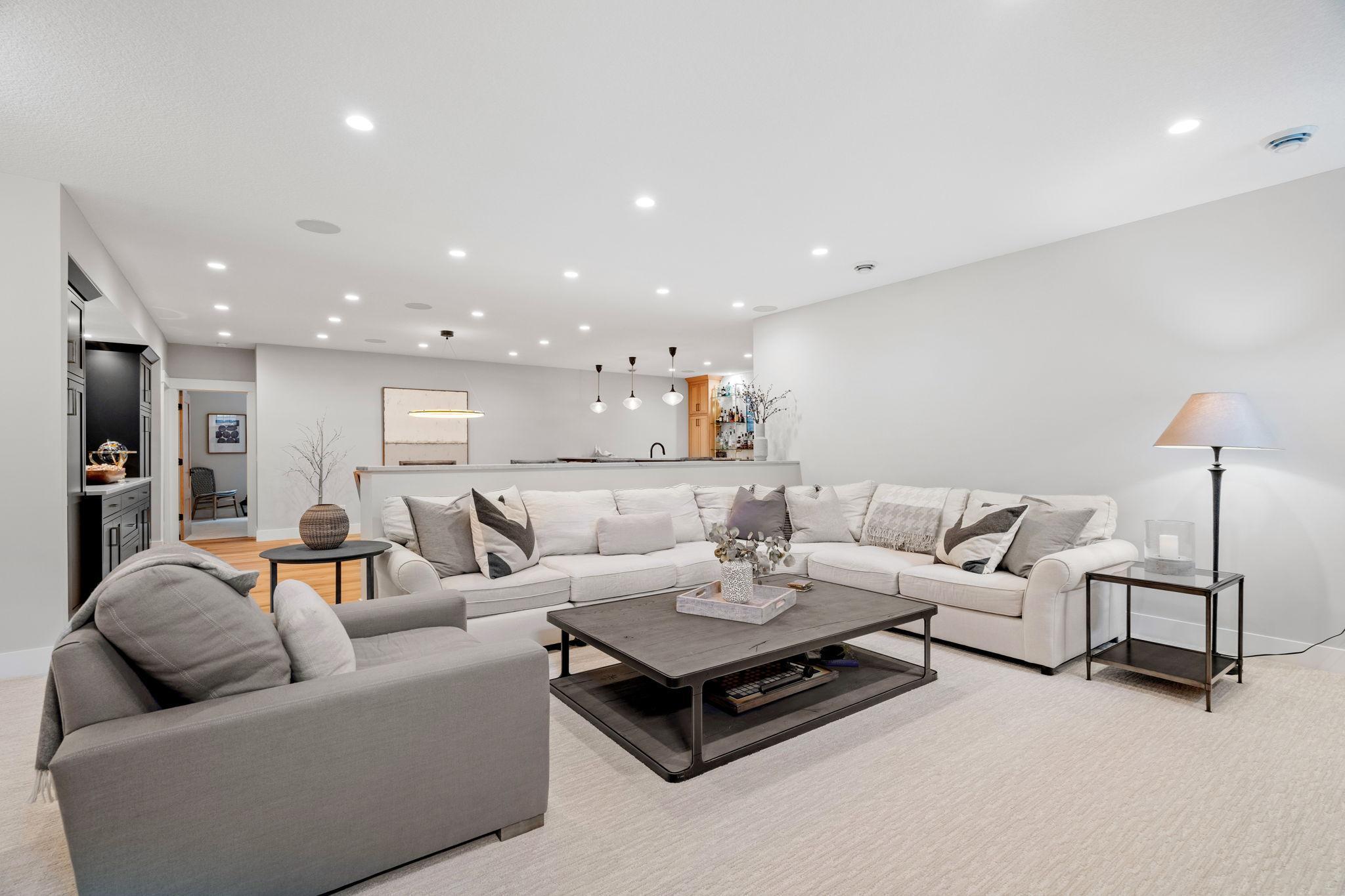 Recessed lighting and built-in speakers throughout the space ensure an inviting atmosphere with excellent sound quality.