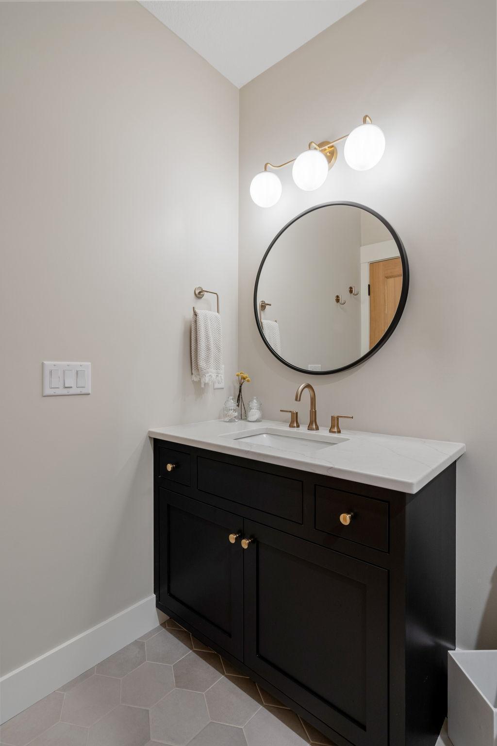 This pass through bathroom has a modern vanity sink that provides convenience for guests.