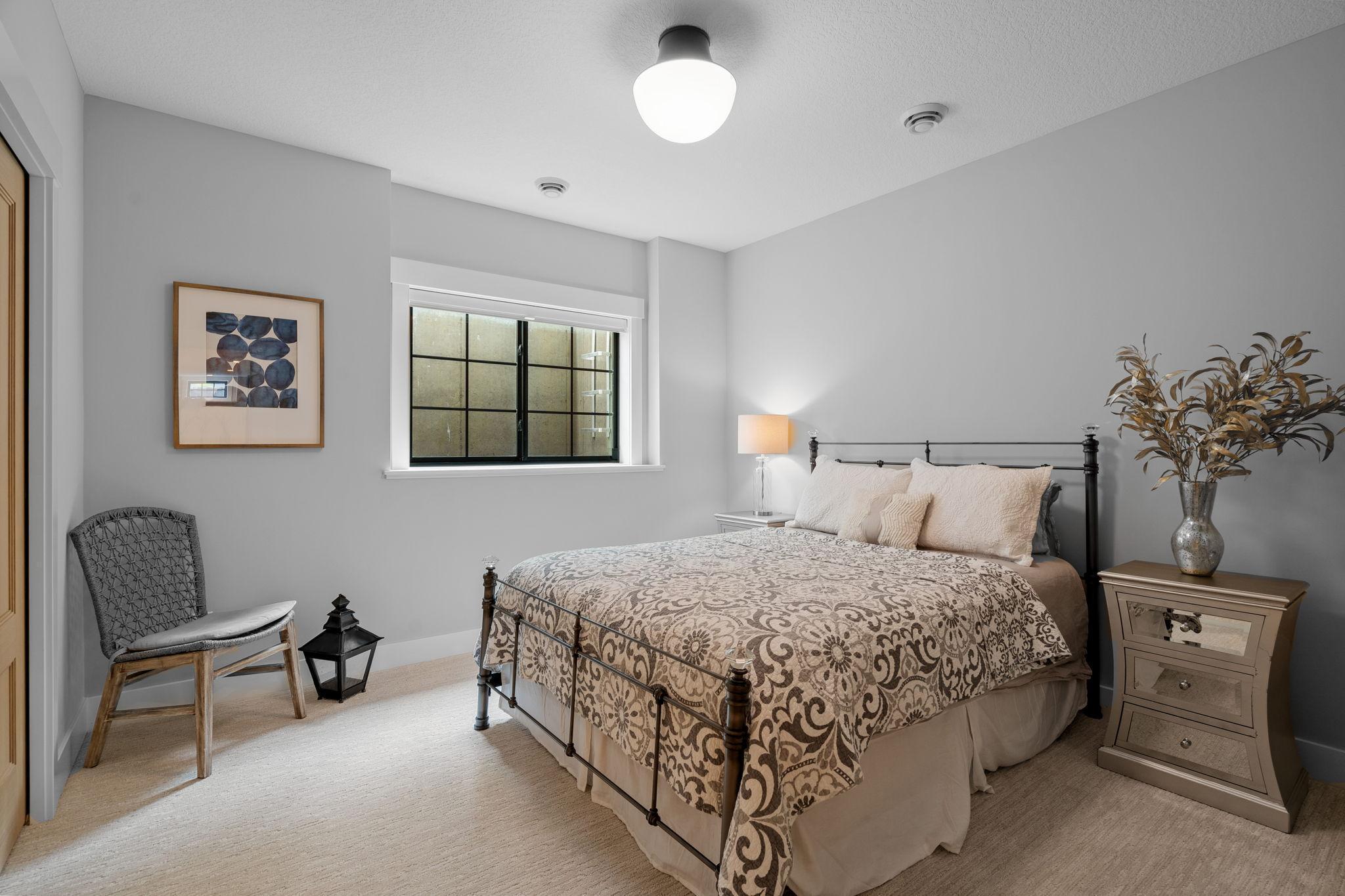 The lower level bedroom with direct access to a stylish 3/4 bathroom.