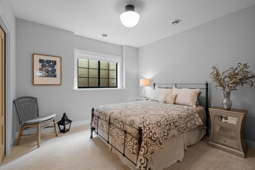 The lower level bedroom with direct access to a stylish 3/4 bathroom.