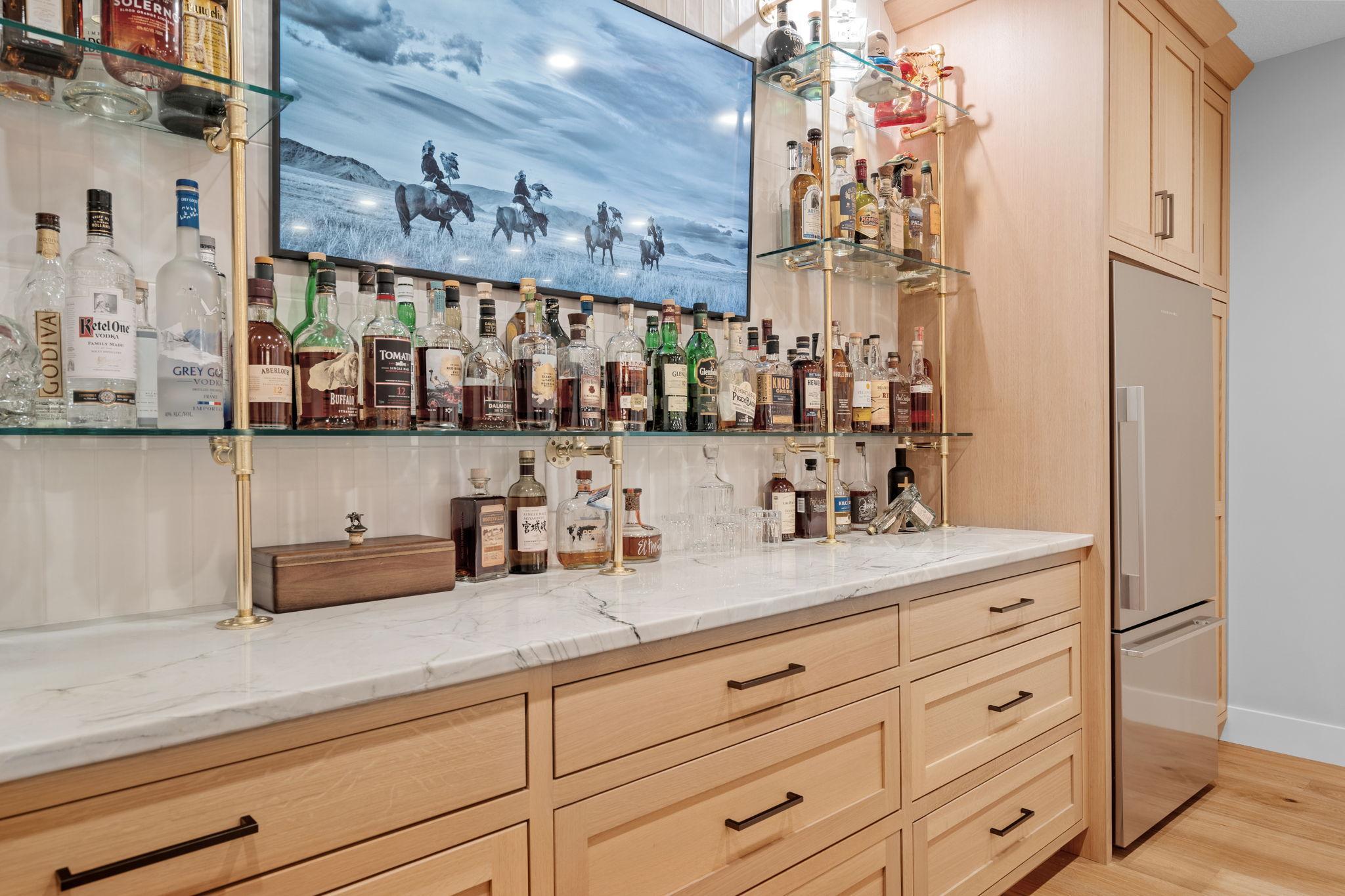 With its seamless blend of style, comfort, and functionality, the lower level bar area offers a sophisticated retreat where friends and family can come together to unwind, celebrate, and create lasting memories.