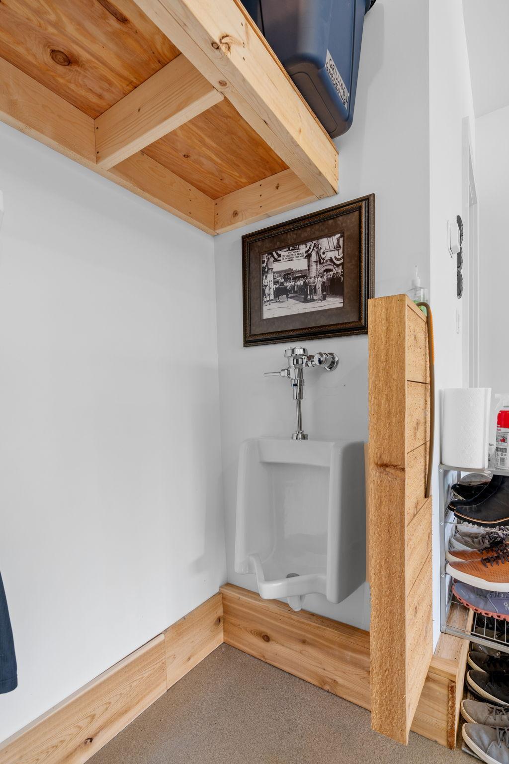 Practical features such as a drain floor, laundry tub, and urinal add to the garage's convenience making it an ideal space for a variety of tasks and projects.