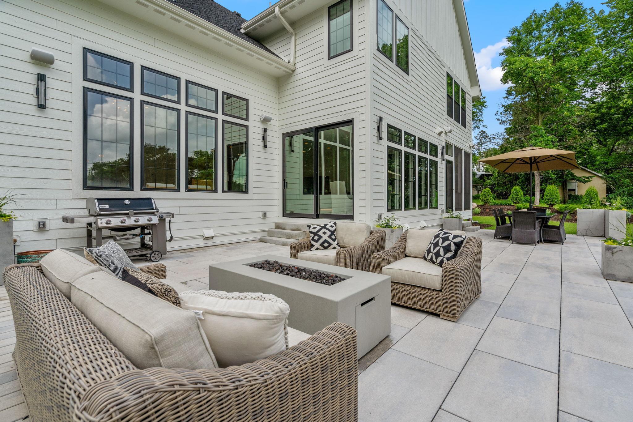 Surrounded by lush landscaping, the home stands as a testament to refined living, offering a sanctuary of beauty and tranquility amidst the bustling world outside.