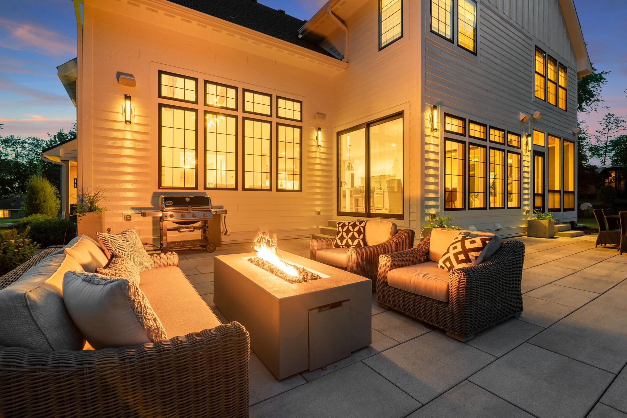 The outdoor living spaces, adorned with cozy seating areas and ambient lighting, offer the perfect setting for al fresco dining and lively conversation under the stars.