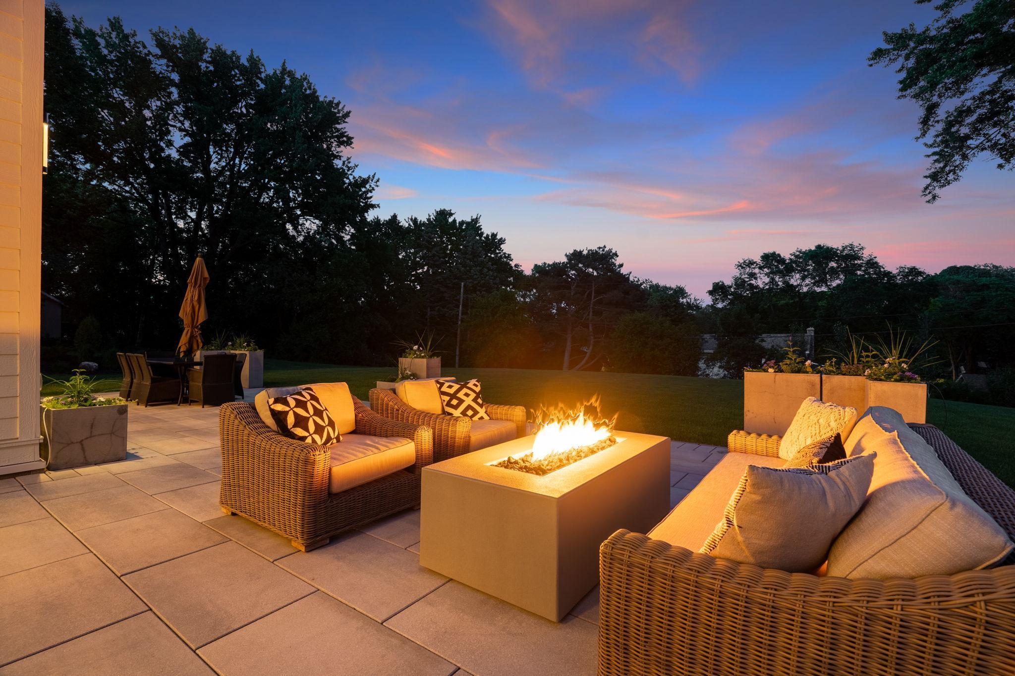 The patio, bathed in the soft glow of the fireplace, provides a cozy retreat for intimate gatherings and quiet conversations.