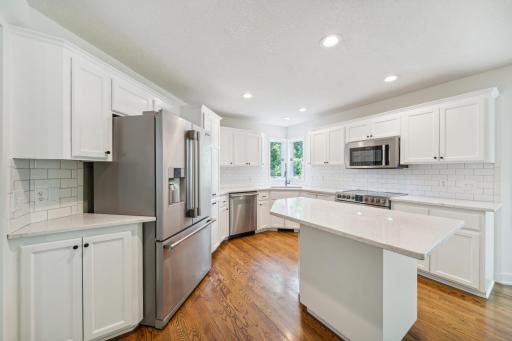 Kitchen with white cabinetry and stainless appliances.