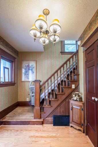 Open staircase that shows the beautiful woodwork, great entry closet for coats, boats, shoes etc