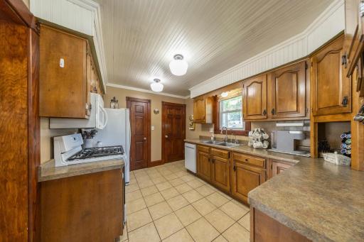 Bead board ceiling, large pantry. Door to left/pantry, to right goes to lower level.