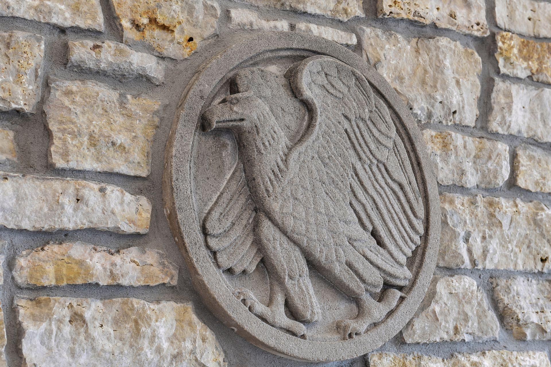 vintage cast eagle medallion incorporated in fireplace facade