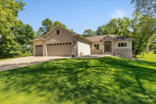 This lovely home features a large 3-stall attached garage with a gas heater, built-in shelving, two-floor drains and in the back of it is a doggie door leading to a fenced-in area. Both overhead garage doors are insulated and have their own openers.