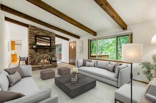 Great room with fireplace and exposed beams - virtually staged