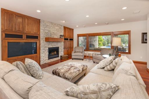 Spacious Lower Level Family Room with built in media and beautiful, stone fireplace