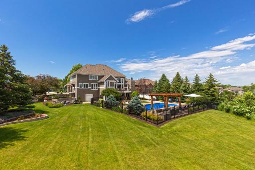 Large Backyard with professional landscaping and fence