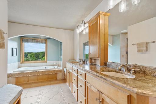 Primary Suite Bathroom with Granite Countertops and Tile