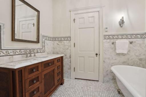 Renovated bathroom has in-floor heat, separate shower, original claw foot tub, marble floors.