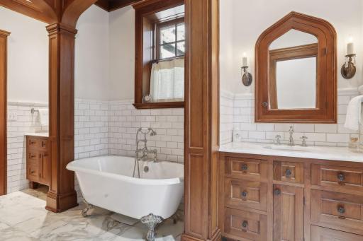 Owner's suite bathroom has custom walnut cabinets, marble floors with in-floor heat, claw foot tub and separate walk-in shower.