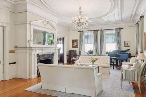 This living room has a gas fireplace and yes, plenty of space for a grand piano. Another view of the totally restored plaster ceilings.