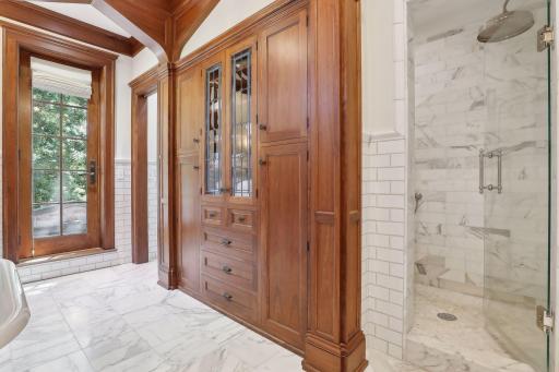 Owner's suite bathroom has custom walnut cabinets, marble floors with in-floor heat, claw foot tub and separate walk-in shower.