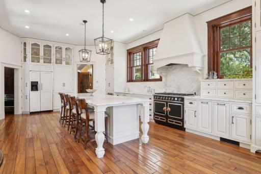 This beautifully renovated kitchen has a large island, marble countertop & backsplash, La Cornue range, extensive cabinets, built in refrigerator, 2 additional refrigerator drawers and heated floors.