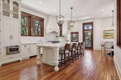 This beautifully renovated kitchen has large island with seating for 4, marble countertop & backsplash, extensive cabinets, and heated floors.