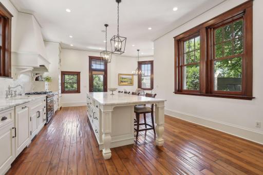This beautifully renovated kitchen has windows on three sides, large island, marble countertop & backsplash, La Cornue range, extensive cabinets, built in refrigerator, 2 additional refrigerator drawers and heated floors.