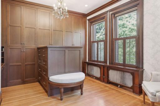 Owner's suite dressing room has custom, walnut cabinets.