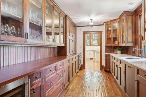 Butler's pantry separates the kitchen and dining room. It includes Liebherr wine refrigerator, built in oven, hand pounded copper sink, Miele dishwasher and extensive additional cabinet space. The pantry also has heated floors.