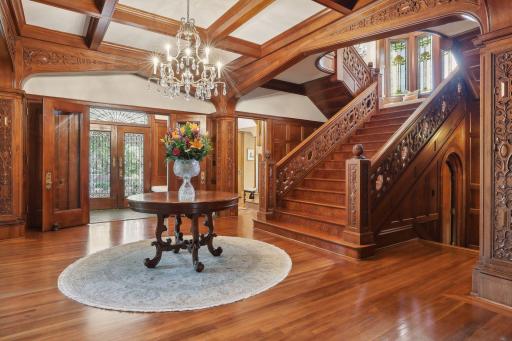 Massive mahogany doors with decorative wrought iron grills open to a tiled vestibule and grand foyer. The 10 1/2 ft wood-beamed ceilings and a dramatic 7-ft wide grand staircase make this an extraordinary entrance for large gatherings.