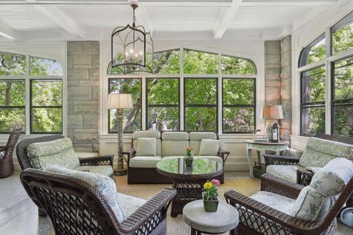Three-season porch runs the length of the house and flows out to a patio for summer entertaining. Note: 3-season porch is excluded from the finished square footage.