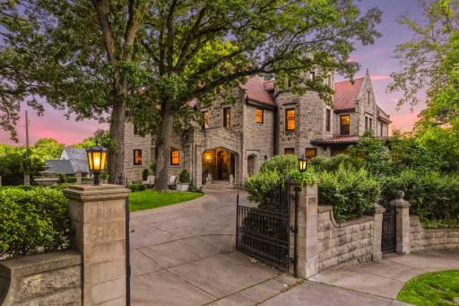 This home sits up on a hill and is surronded by the original stone walls and decorative iron gates.