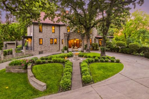 This home has a sweeping circular drive with a grand covered entrance.