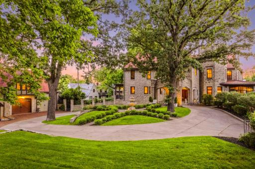 This home has a sweeping circular drive with a grand covered entrance.