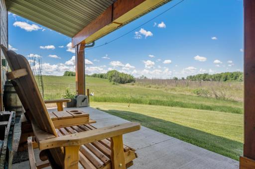 Outbuilding has its own porch overlooking the lake, woods, apple and cherry trees.