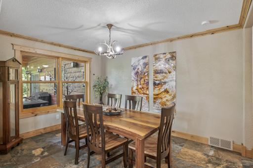 The dining room is the perfect place for large gatherings. Live edge walnut dining room table with six chairs is negotiable. The window opens to "pass through" to the patio.