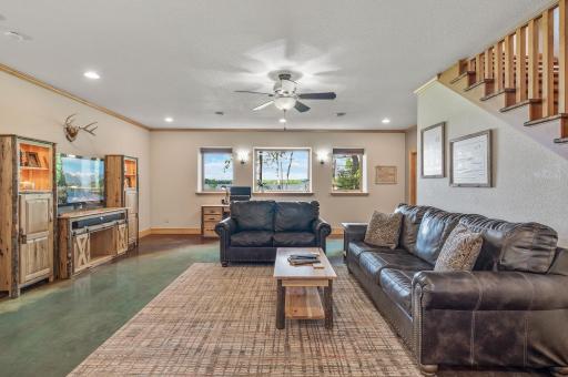 The lower level family room is perfect place to relax or entertain. Pine entertainment center, desk, and file cabinet are negotiable.