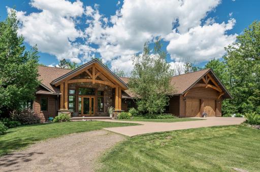 This solid 2015 built home features hand cut white pine timbers, knotty alder woodwork, walnut hardwood floors, Marvin windows, a Heat N Glow fireplace, and dream come true views of the lake.