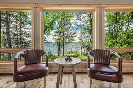 A wall of windows in the great room seamlessly brings the outside in, offering stunning views of the lake.