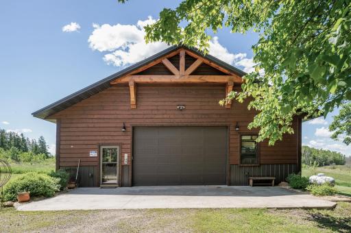 Garage door on the outbuilding measures 16 ft wide by 10 ft tall to accommodate large vehicles.