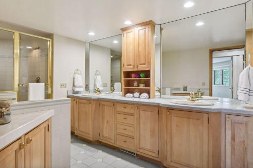 large bath with double vanity and separate tub and shower