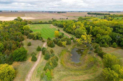 154 acres - including wooded, high ground, pasture, creek, pond, and 5 miles of trails
