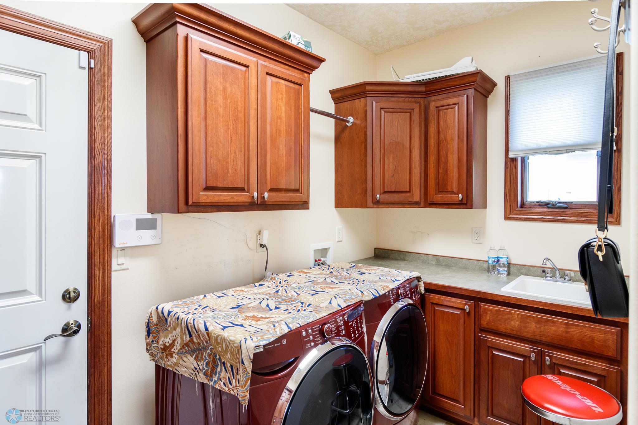 Main Floor Laundry with Extra Cabinets and Sink
