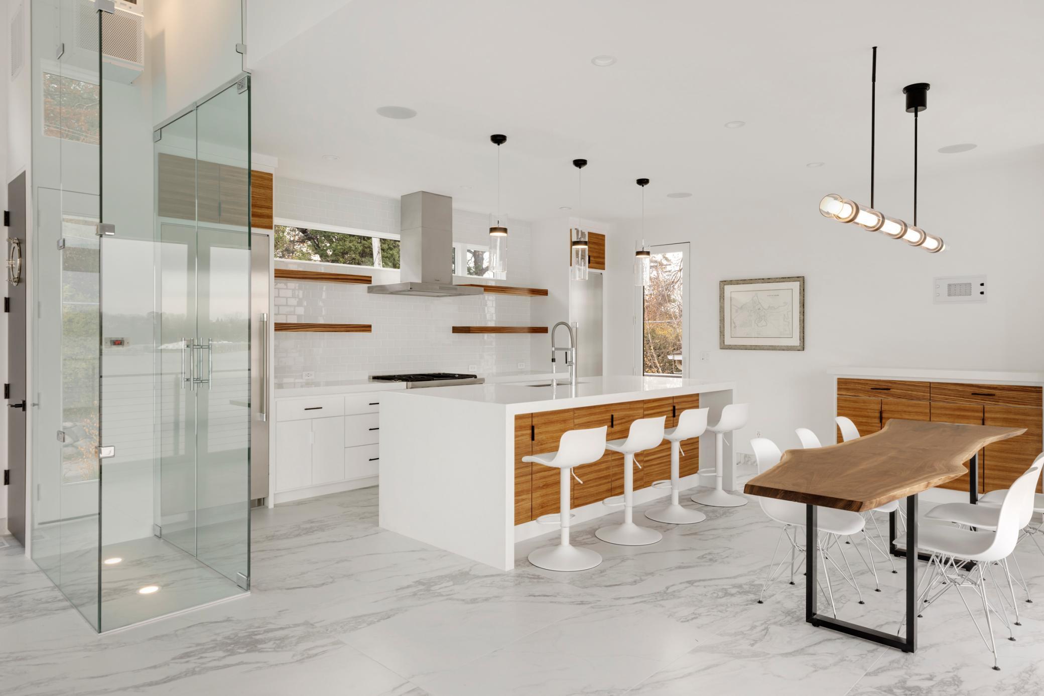 The glass enclosure is a temp controlled wine cellar. The door off the kitchen leads to a grill deck and patio.