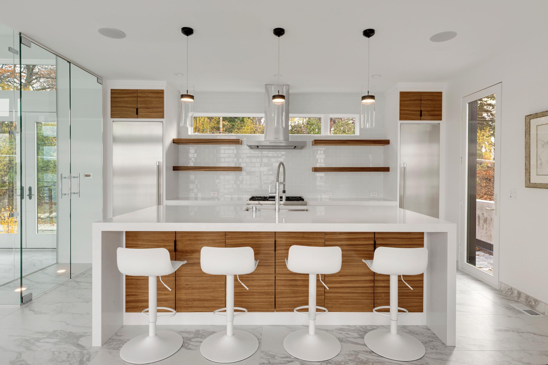 Custom zebrawood cabinetry adorns and warms the kitchen space.
