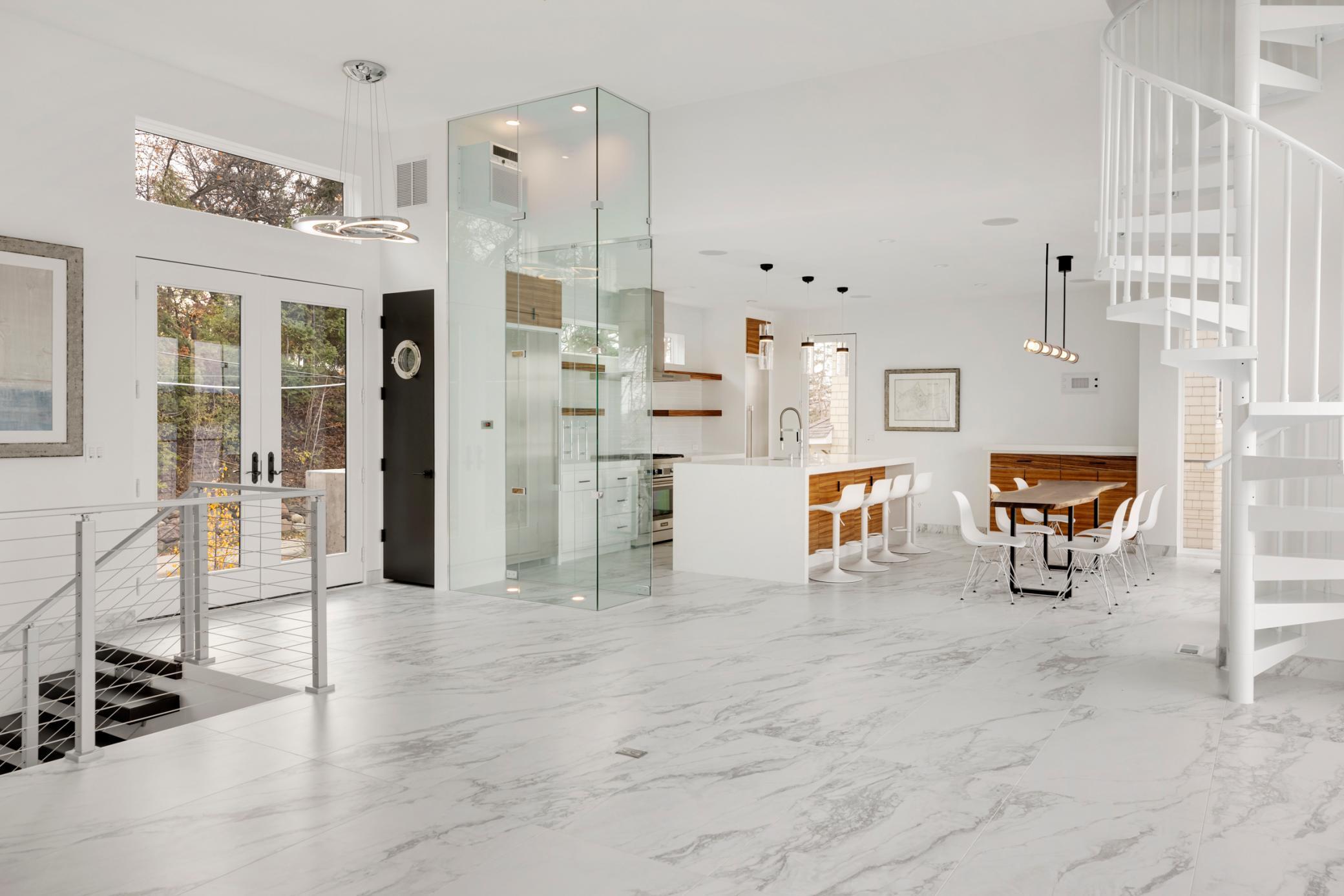 The open kitchen features a separate refrigerator and freezer and top-of-the-line stainless steel appliances.