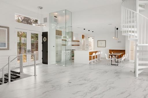 The open kitchen features a separate refrigerator and freezer and top-of-the-line stainless steel appliances.