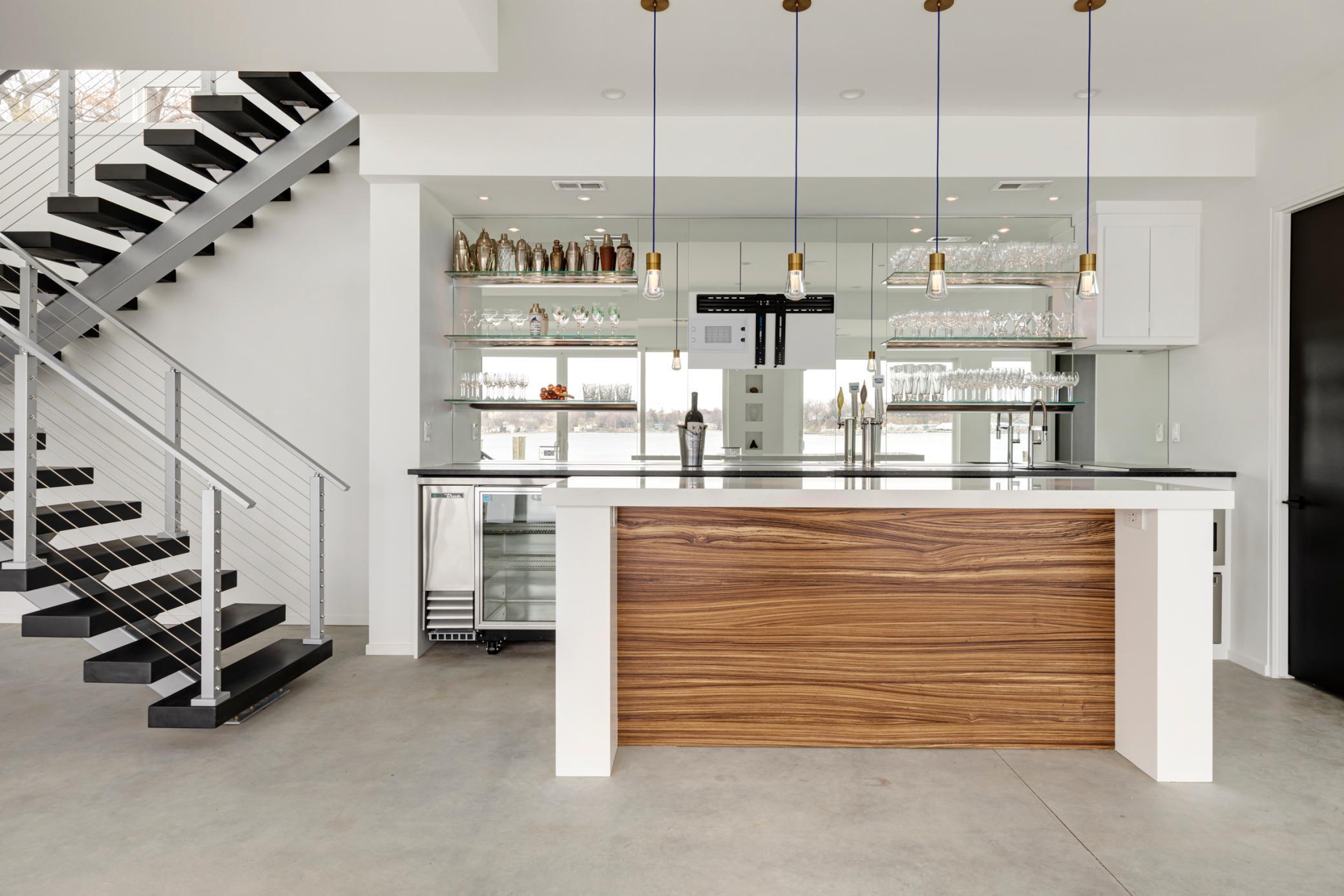 Zebrawood accents the glass and steel, while the mirrors reflect the lake.