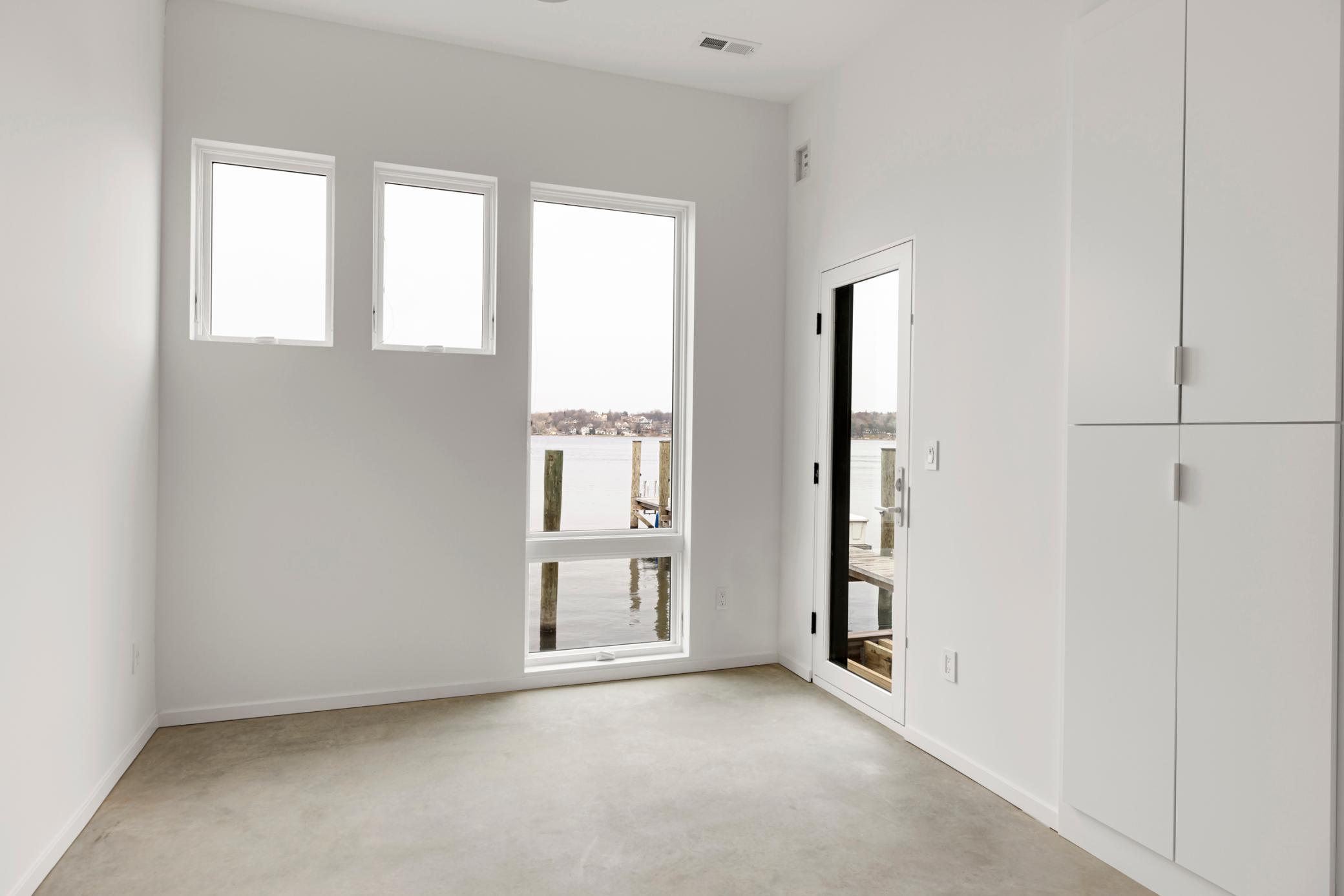 This lower level bedroom has a bathroom across from it.