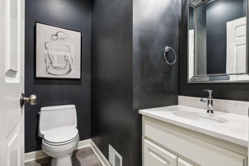 The powder room’s location off the mudroom makes it easily accessible for both residents and visitors, providing a convenient restroom option on the main floor of the home.