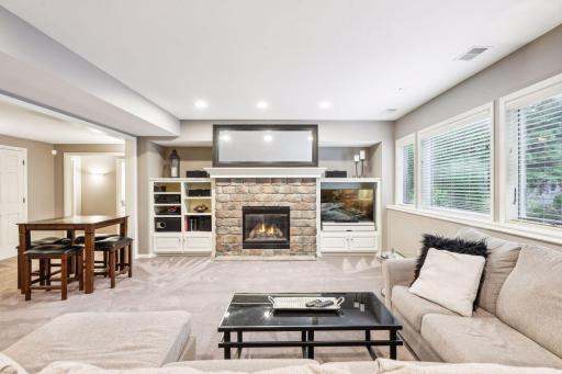 A cozy gas fireplace anchors the space and the custom built-ins are ideal for tucking away blankets or stashing board games.