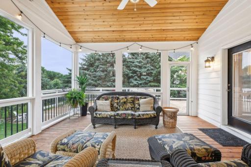 The amazing screen porch is a serene oasis that seamlessly blends the comfort of indoor living with the beauty of the outdoors.